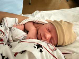 A peaceful newborn resting on the mother's chest immediately after birth following Birth Hypnosis preparation. This real family experience highlights the benefits of hypnosis for childbirth, including relaxation, confidence, parent and baby bonding, and a calm birth experience.